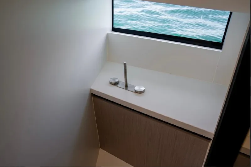 Slide: The Image of Modern bathroom sink on Maori 54ft XL yacht, 2025 model, with ocean view window. - 23