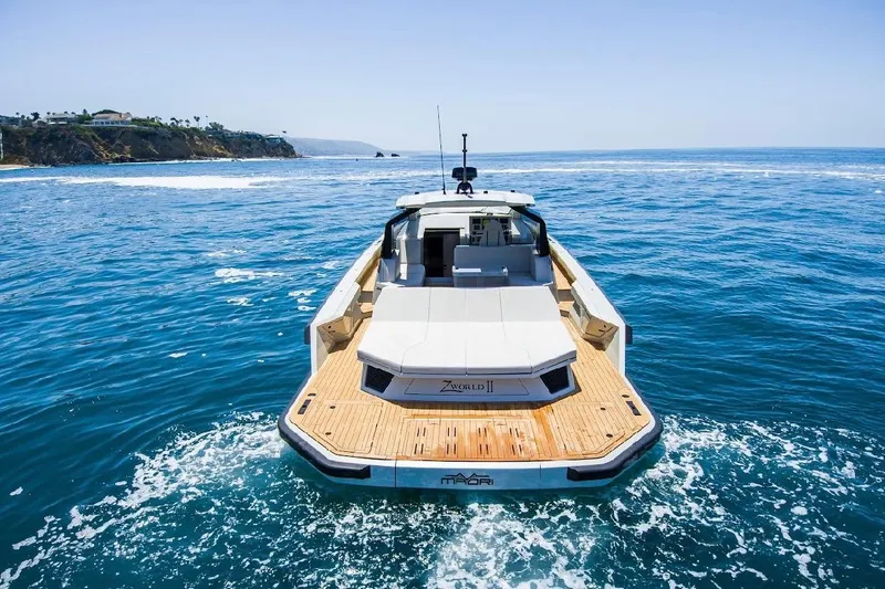Slide: The Image of 2025 Maori 54ft XL yacht cruising on open sea near rocky coastline. - 5