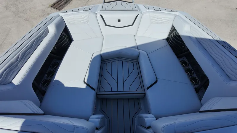 Slide: The Image of Luxurious seating area of 2026 Nautique Paragon G23 boat, featuring sleek design and cup holders. - 16
