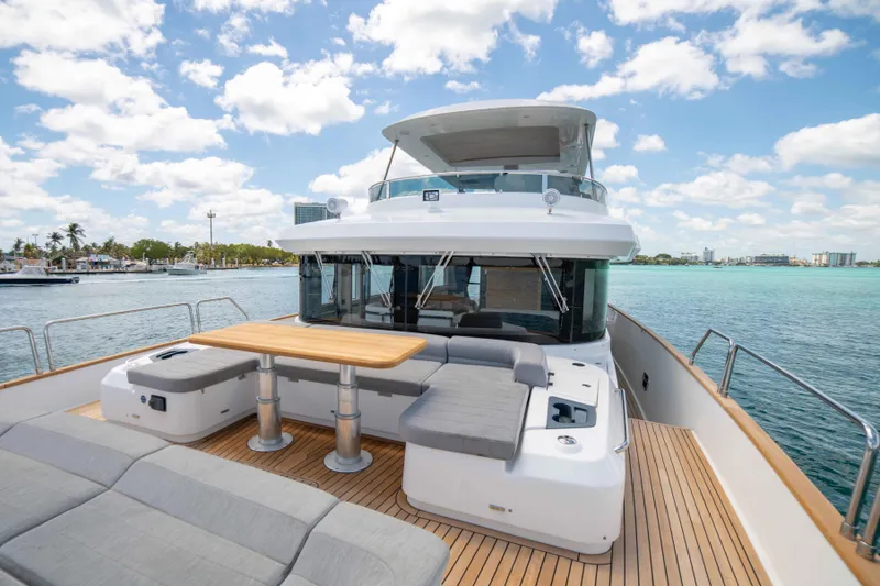 Slide: The Image of 2018 Sirena 64 yacht with spacious deck and seating area on a sunny day. - 10