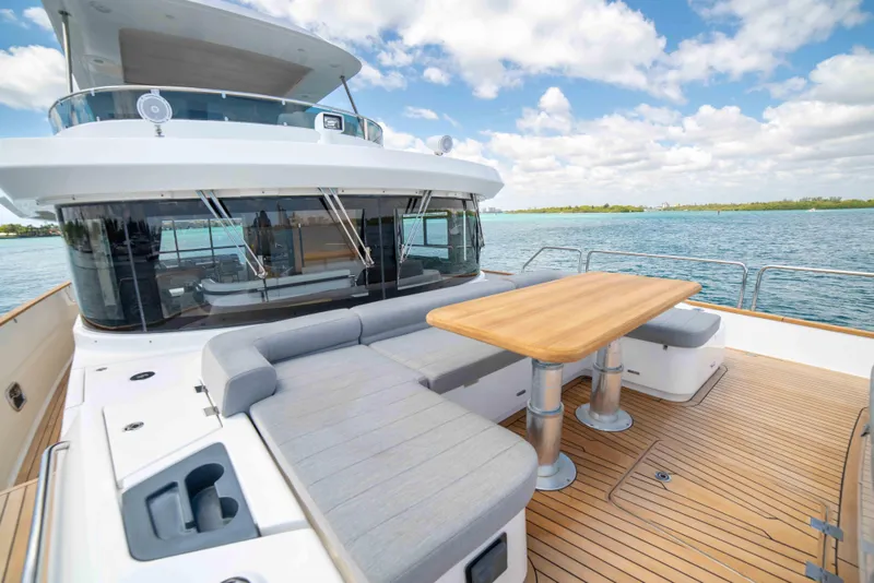 Slide: The Image of 2018 Sirena 64 yacht with outdoor seating and dining area on deck. - 14
