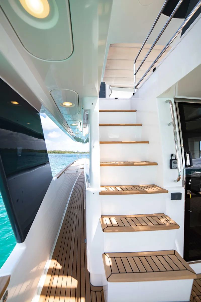 Slide: The Image of 2018 Sirena 64 yacht with teak deck and staircase, modern design. - 18