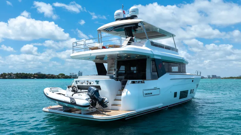 Slide: The Image of Luxury 2018 Sirena 64 yacht cruising on clear blue waters under a sunny sky. - 9