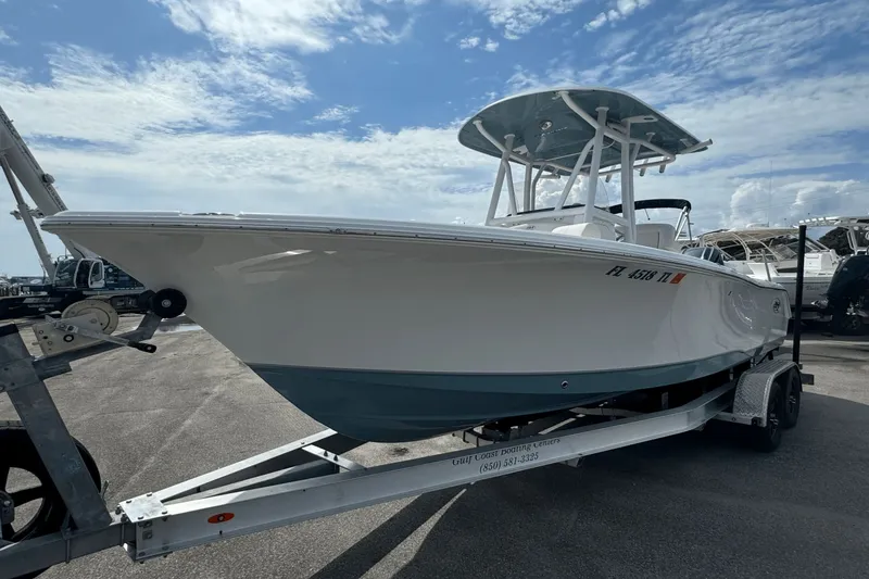 Slide: The Image of 2023 Sea Hunt 234 Ultra boat on trailer under a partly cloudy sky. - 1