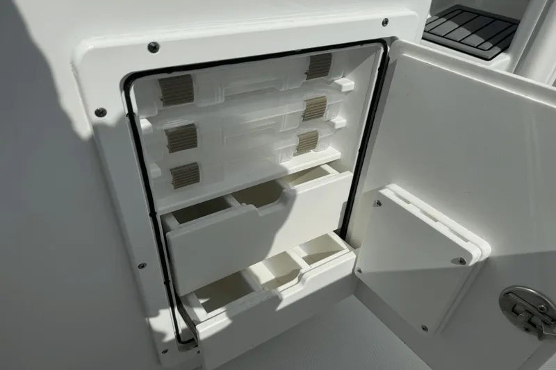 Slide: The Image of Storage compartment on 2023 Sea Hunt 234 Ultra boat, featuring organized interior shelves. - 13
