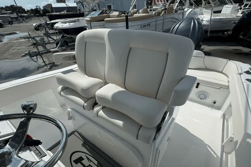 Slide: The Image of 2023 Sea Hunt 234 Ultra boat with dual white captain's chairs and steering wheel. - 14