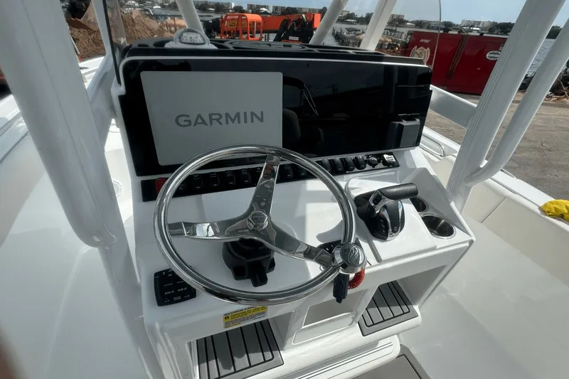 Slide: The Image of 2023 Sea Hunt 234 Ultra boat console with Garmin display and steering wheel. - 15