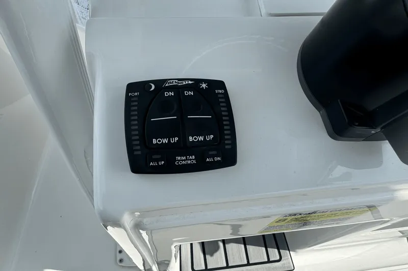 Slide: The Image of 2023 Sea Hunt 234 Ultra trim tab control panel on boat console. - 17