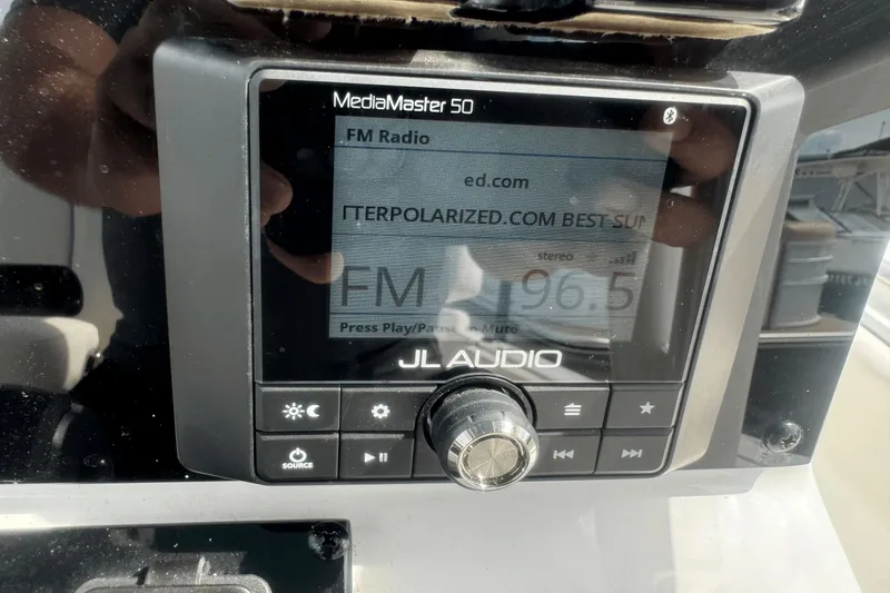 Slide: The Image of JL Audio MediaMaster 50 radio display on 2023 Sea Hunt 234 Ultra boat dashboard. - 21