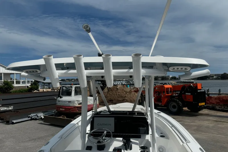 Slide: The Image of 2023 Sea Hunt 234 Ultra boat with Garmin equipment, docked near construction site. - 24