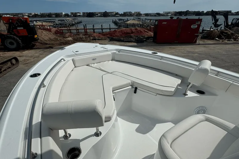 Slide: The Image of 2023 Sea Hunt 234 Ultra boat with spacious seating, docked near a waterfront. - 28