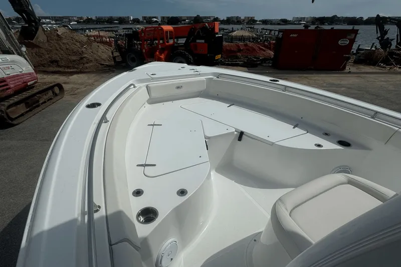 Slide: The Image of 2023 Sea Hunt 234 Ultra boat interior with seating and storage, dockside view. - 29