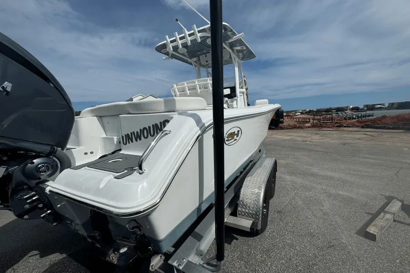 Slide: The Image of 2023 Sea Hunt 234 Ultra boat on trailer, parked near waterfront. - 3