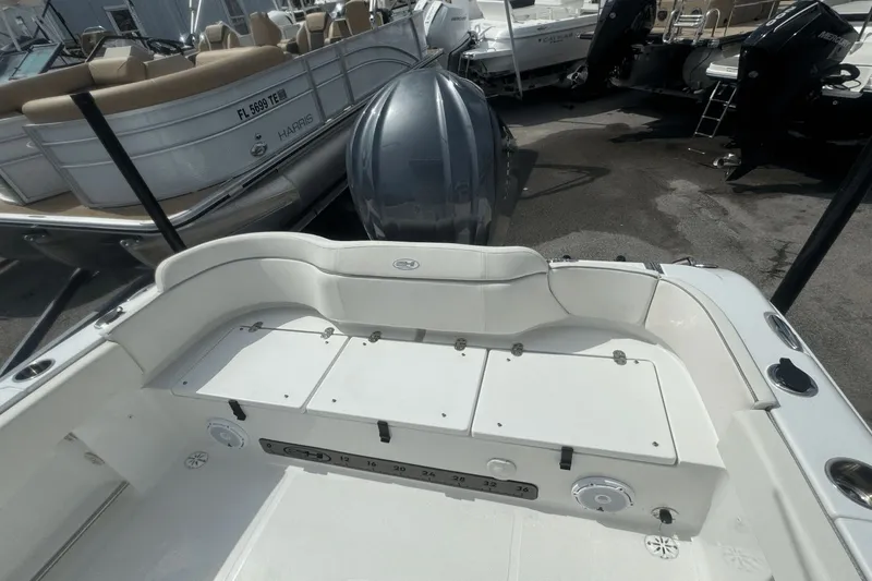 Slide: The Image of 2023 Sea Hunt 234 Ultra boat interior with seating and storage compartments. - 7