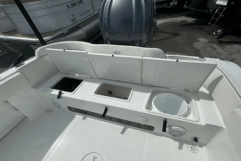 Slide: The Image of 2023 Sea Hunt 234 Ultra boat interior with storage compartments and fishing features. - 8