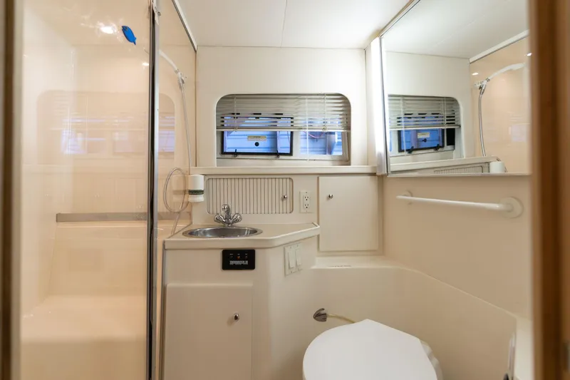 Slide: The Image of 1998 Carver 355 Aft Cabin bathroom with sink, toilet, and shower. - 11