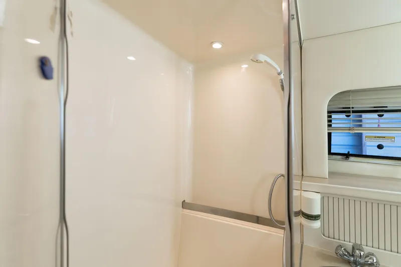 Slide: The Image of 1998 Carver 355 Aft Cabin bathroom with shower and window. - 12