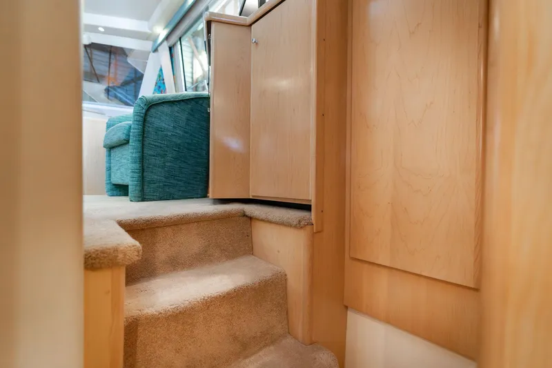 Slide: The Image of Interior of 1998 Carver 355 Aft Cabin with carpeted stairs and wooden cabinetry. - 13