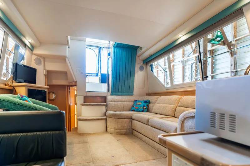 Slide: The Image of Interior of 1998 Carver 355 Aft Cabin yacht with cozy seating and modern amenities. - 14