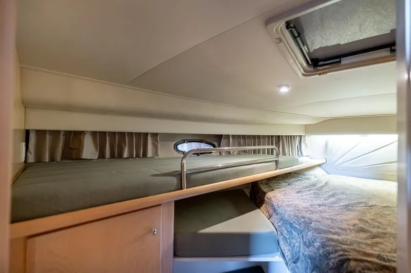 Slide: The Image of 1998 Carver 355 Aft Cabin interior with cozy sleeping area and natural light. - 19
