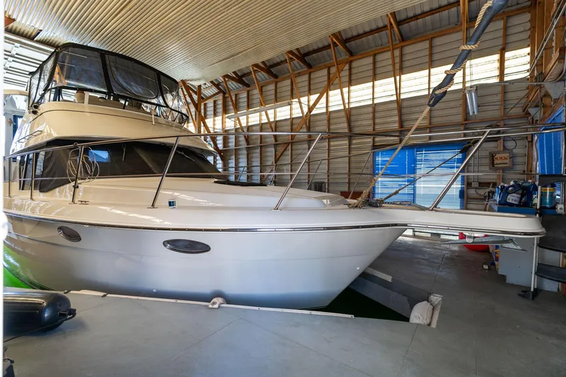 Slide: The Image of 1998 Carver 355 Aft Cabin yacht in a boat storage facility. - 2