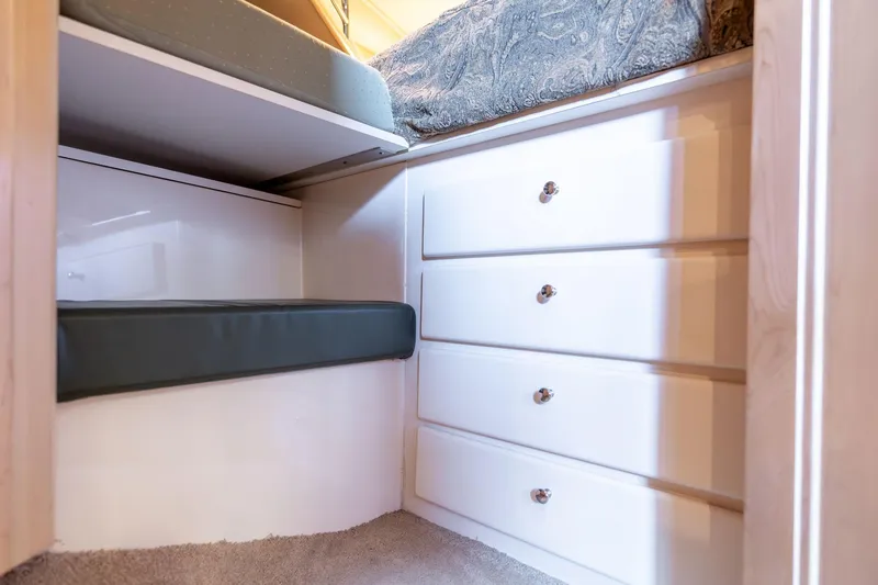 Slide: The Image of 1998 Carver 355 Aft Cabin interior with white drawers and cushioned seating. - 22