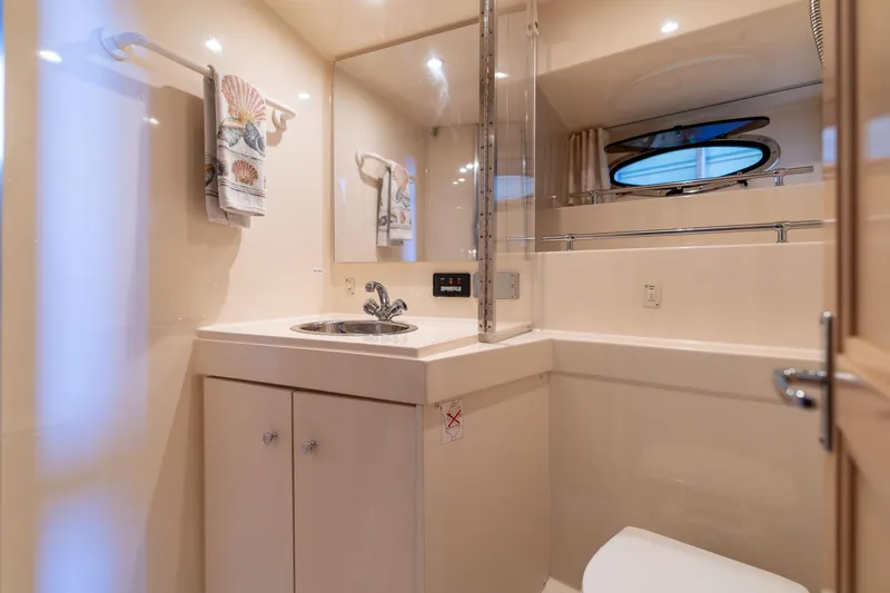 Slide: The Image of 1998 Carver 355 Aft Cabin bathroom with sink, mirror, and towel rack. - 23