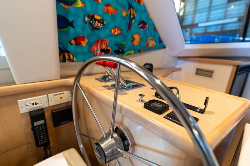 Slide: The Image of Interior helm of 1998 Carver 355 Aft Cabin with colorful fish-themed curtain. - 25