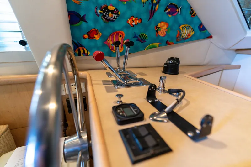 Slide: The Image of 1998 Carver 355 Aft Cabin helm with colorful fish curtain and navigation controls. - 26