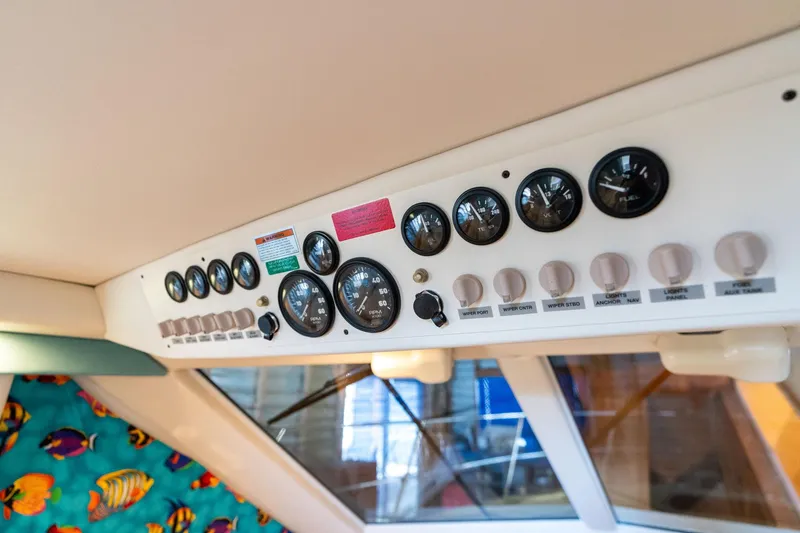Slide: The Image of Control panel of a 1998 Carver 355 Aft Cabin boat with gauges and switches. - 27