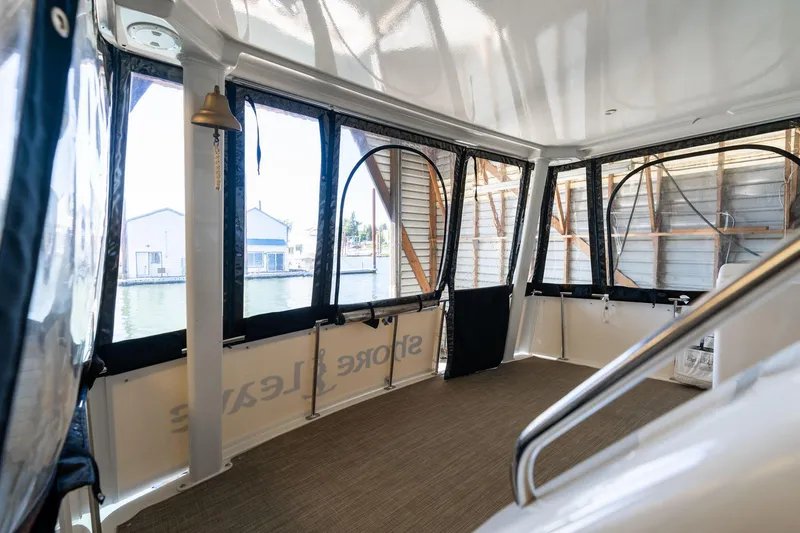 Slide: The Image of 1998 Carver 355 Aft Cabin interior with large windows and waterfront view. - 28