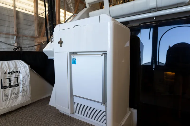 Slide: The Image of 1998 Carver 355 Aft Cabin interior with compact refrigerator and lifesaving equipment. - 29