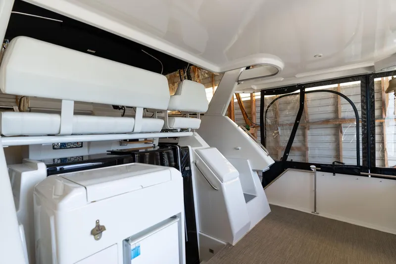 Slide: The Image of 1998 Carver 355 Aft Cabin interior with white seating and modern amenities. - 31