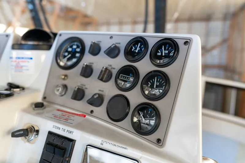 Slide: The Image of Control panel of a 1998 Carver 355 Aft Cabin boat with gauges and switches. - 34
