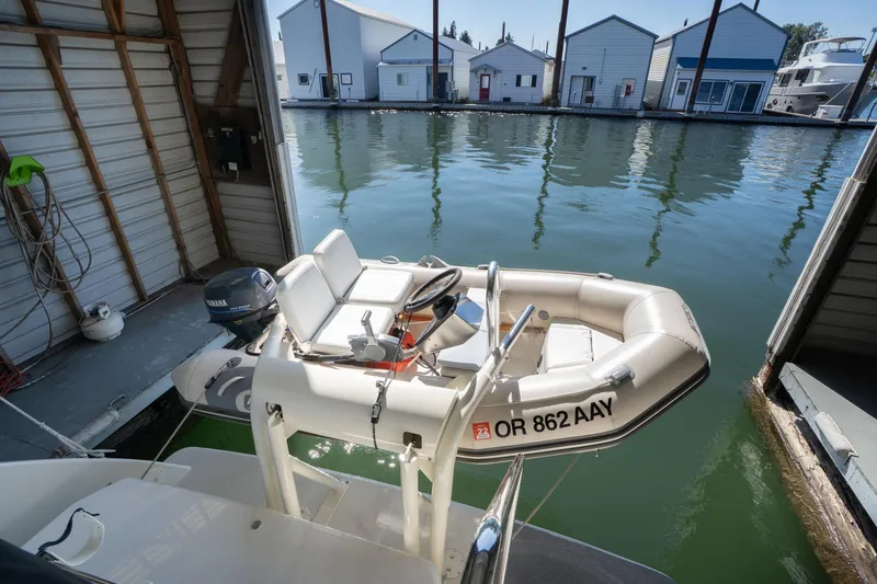 Slide: The Image of Inflatable boat docked near Carver 355 Aft Cabin, 1998, in a marina setting. - 39