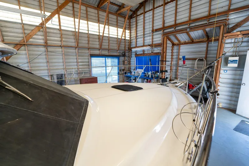 Slide: The Image of 1998 Carver 355 Aft Cabin yacht in a spacious indoor storage facility. - 40