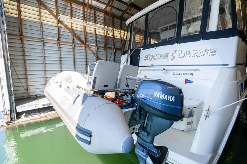 Slide: The Image of 1998 Carver 355 Aft Cabin with Yamaha motor in a boat shed. - 43