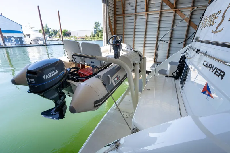 Slide: The Image of 1998 Carver 355 Aft Cabin with Yamaha outboard motor in marina setting. - 44