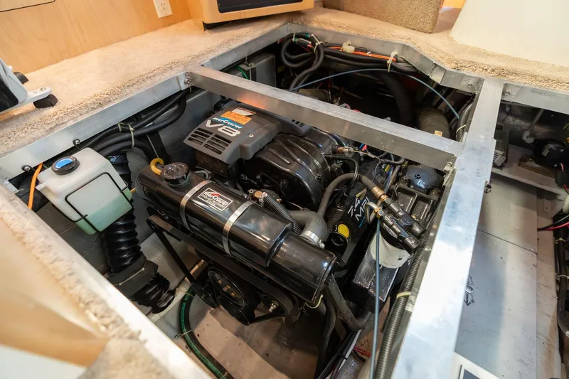 Slide: The Image of Engine compartment of a 1998 Carver 355 Aft Cabin boat, showcasing mechanical components. - 48