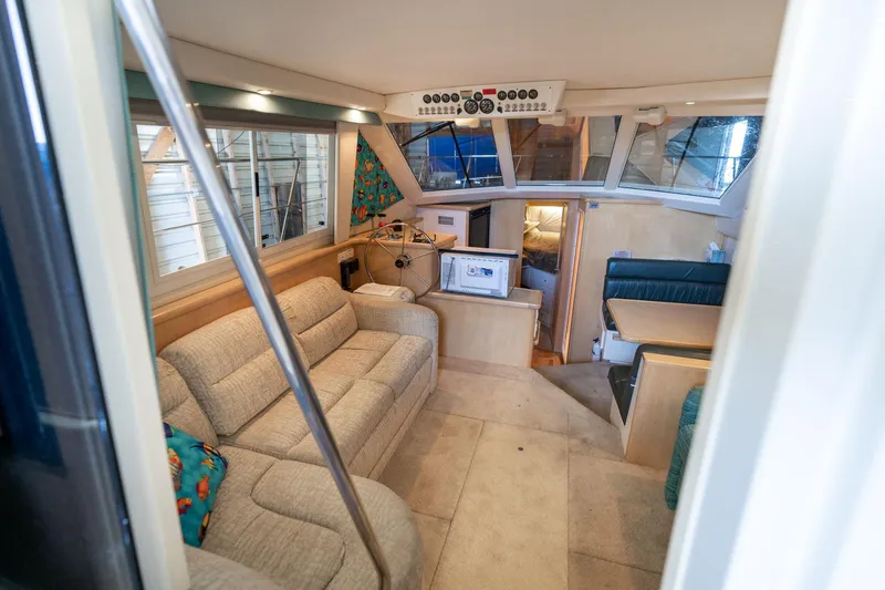 Slide: The Image of Interior of 1998 Carver 355 Aft Cabin yacht with cozy seating and helm. - 5