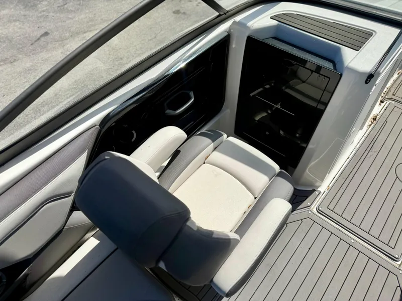 Slide: The Image of 2017 Yamaha Boats 212 Limited S interior with seating and storage area. - 10