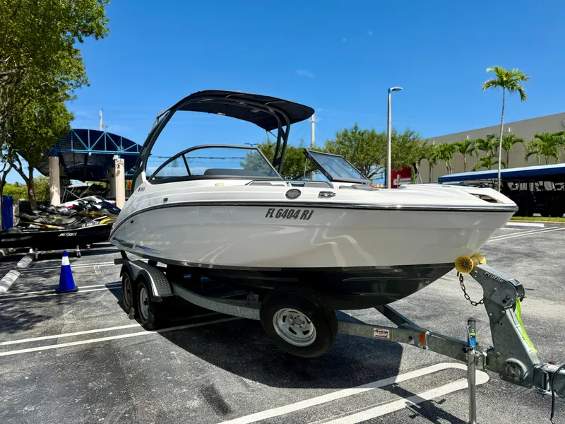 Slide: The Image of 2017 Yamaha Boats 212 Limited S on trailer in parking lot, sunny day. - 3