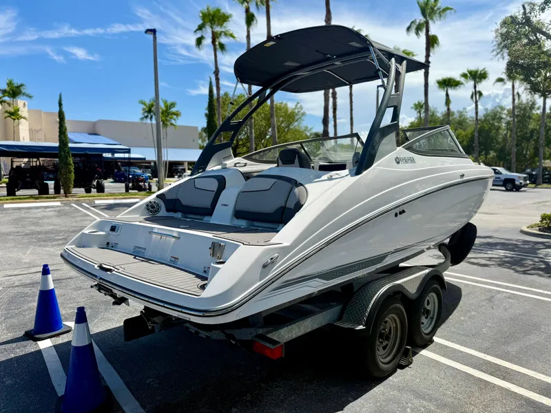 Slide: The Image of 2017 Yamaha Boats 212 Limited S on trailer in sunny parking lot. - 5