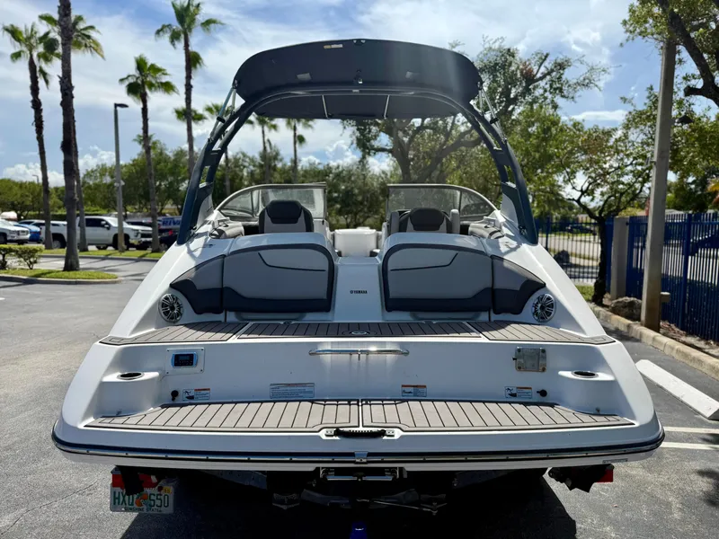 Slide: The Image of 2017 Yamaha Boats 212 Limited S in parking lot, rear view with palm trees. - 6