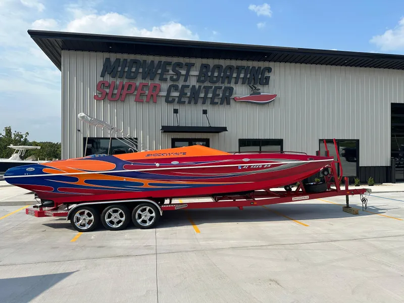 Slide: The Image of 2008 Shockwave Fundeck boat on trailer at Midwest Boating Super Center. - 0