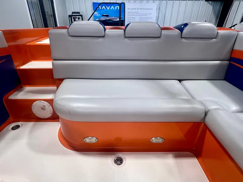Slide: The Image of 2008 Shockwave Fundeck boat interior with orange and gray seating and steps. - 11