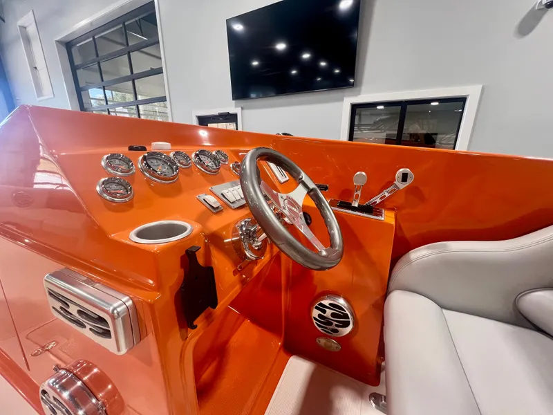 Slide: The Image of 2008 Shockwave Fundeck boat interior with orange dashboard and steering wheel. - 14
