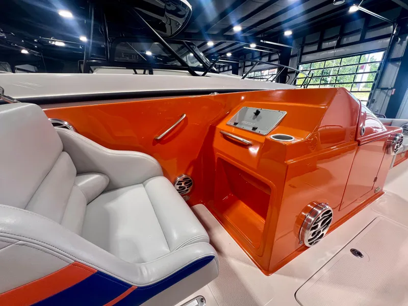 Slide: The Image of 2008 Shockwave Fundeck boat interior with orange console and white seating. - 15
