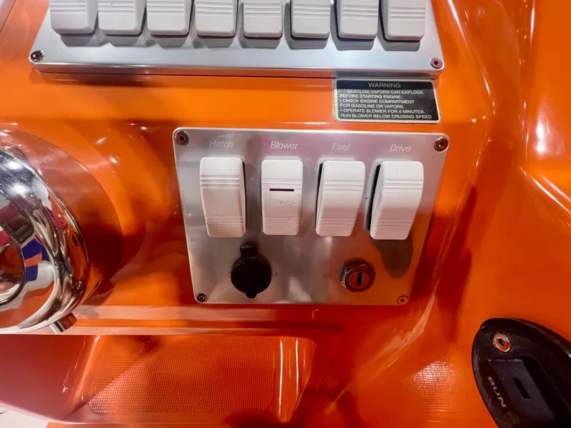 Slide: The Image of Control panel of a 2008 Shockwave Fundeck boat with labeled switches and warning sign. - 18