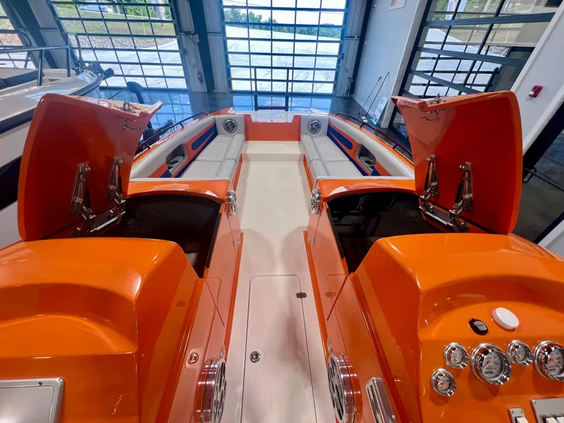 Slide: The Image of 2008 Shockwave Fundeck boat interior with vibrant orange accents and open storage compartments. - 20